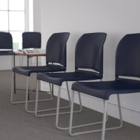 Flash Furniture RUT-238A-NY-GG HERCULES Series 880 lb. Capacity Navy Full Back Contoured Stack Chair with Gray Powder Coated Sled Base